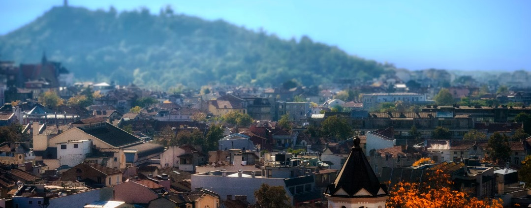 Rooftops in front of a forested hillside in Bulgaria