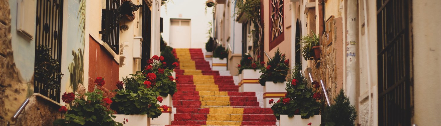 In a European old town setting, steps painted the colours of the Spanish flag